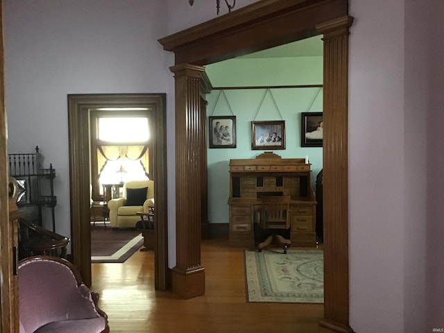 entryway featuring ornate columns and wood finished floors