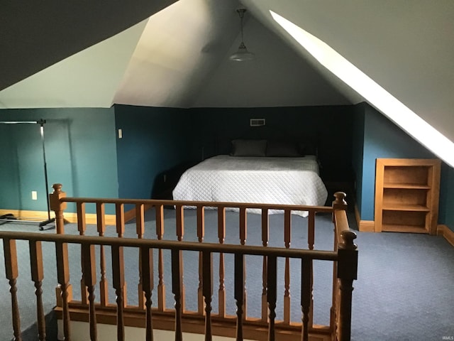 bedroom featuring carpet floors, baseboards, lofted ceiling with skylight, and visible vents