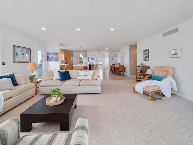 11523 N Crowdale Dr, Syracuse, IN 46567 - living room featuring light colored carpet, baseboards, visible vents, and recessed lighting