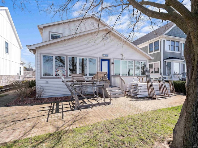 11523 N Crowdale Dr, Syracuse, IN 46567 - rear view of house with a wooden deck and a patio