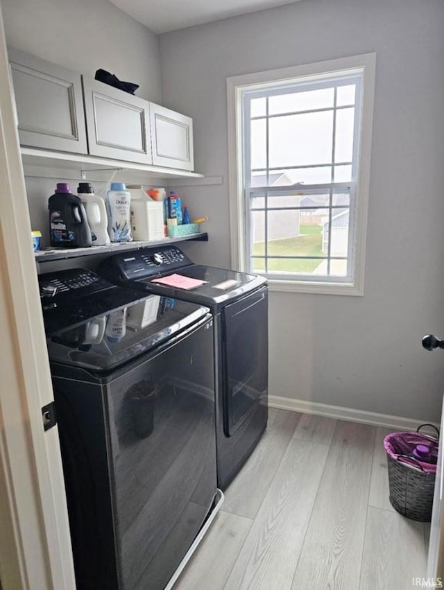 1332 Pueblo Trl, Fort Wayne, IN 46845 - clothes washing area featuring cabinet space, independent washer and dryer, light wood finished floors, and baseboards