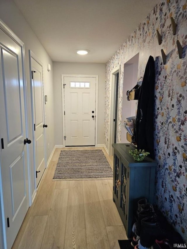 1332 Pueblo Trl, Fort Wayne, IN 46845 - foyer featuring light wood finished floors, baseboards, and wallpapered walls