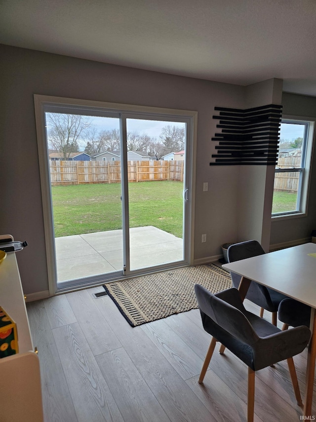 1332 Pueblo Trl, Fort Wayne, IN 46845 - doorway with healthy amount of natural light, light wood-style flooring, and baseboards