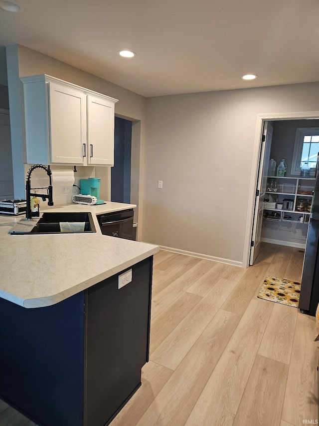 1332 Pueblo Trl, Fort Wayne, IN 46845 - kitchen with a sink, light wood-type flooring, light countertops, recessed lighting, and white cabinetry