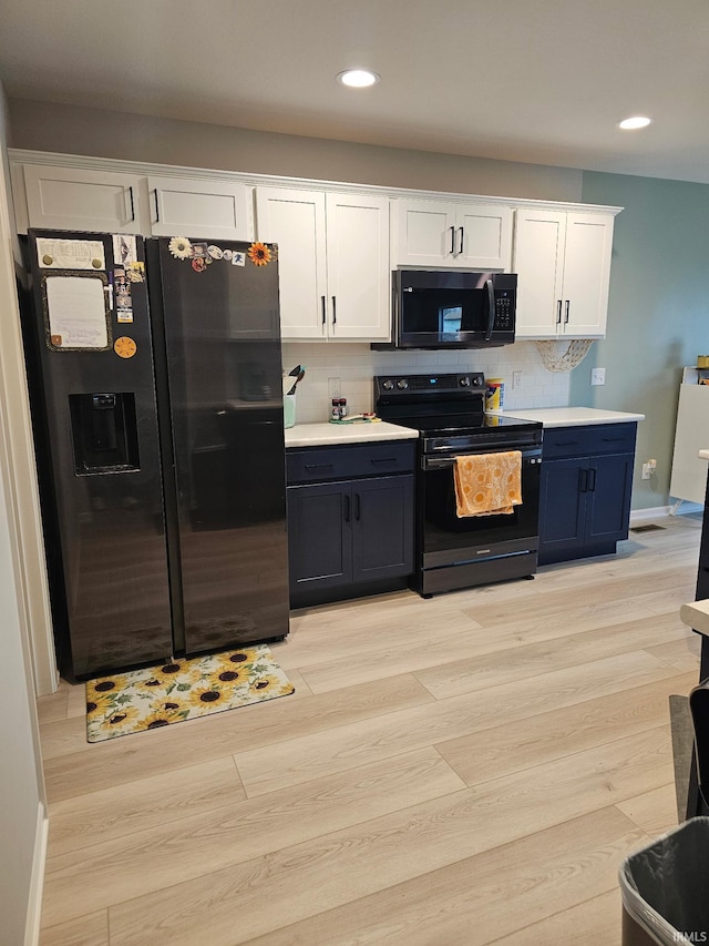 1332 Pueblo Trl, Fort Wayne, IN 46845 - kitchen with black appliances, white cabinetry, recessed lighting, decorative backsplash, and baseboards