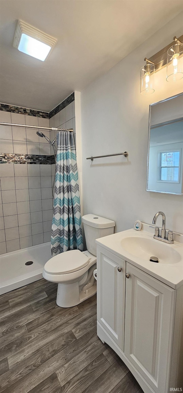 910 Harriet St, Evansville, IN 47710 - bathroom featuring toilet, a shower stall, vanity, and wood finished floors
