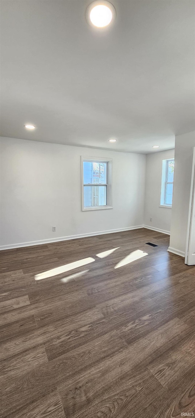 910 Harriet St, Evansville, IN 47710 - spare room with baseboards, dark wood-style floors, visible vents, and recessed lighting