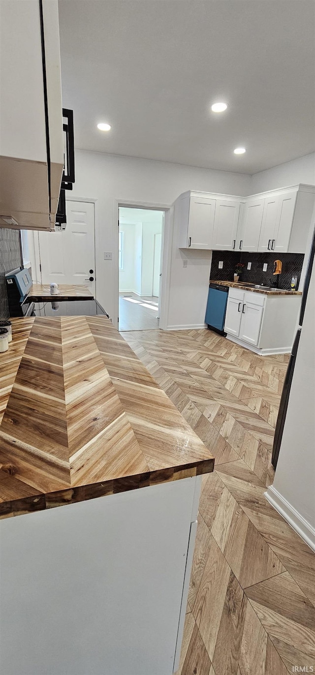 910 Harriet St, Evansville, IN 47710 - kitchen with recessed lighting, wood counters, baseboards, and white cabinetry
