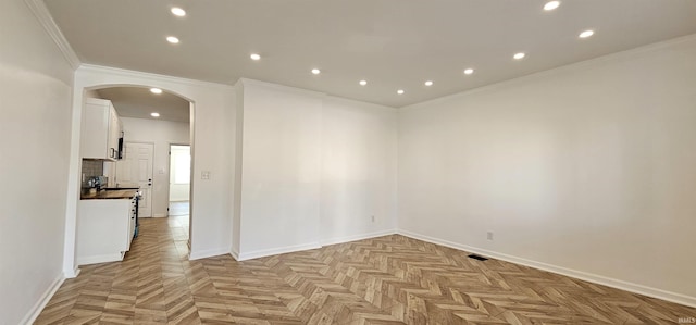 910 Harriet St, Evansville, IN 47710 - empty room featuring crown molding, baseboards, recessed lighting, and arched walkways