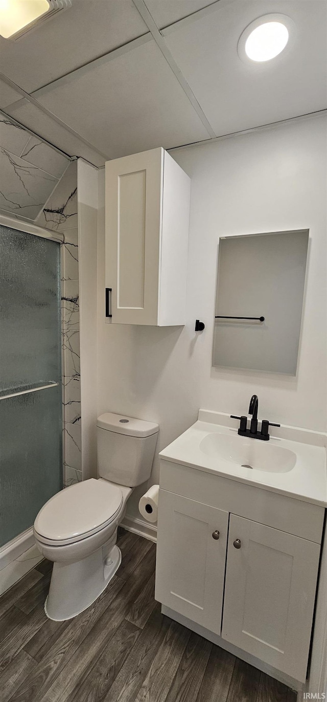 910 Harriet St, Evansville, IN 47710 - bathroom featuring vanity, toilet, wood finished floors, a stall shower, and baseboards