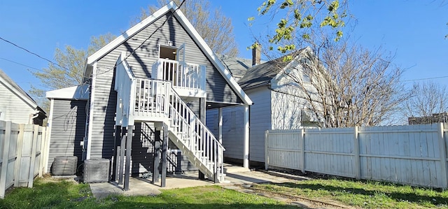 910 Harriet St, Evansville, IN 47710 - back of property with central AC unit, a fenced backyard, and stairway