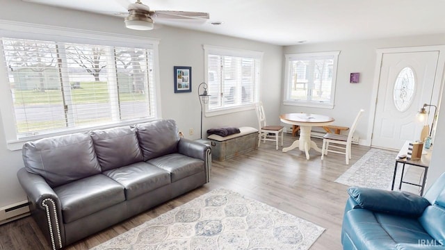10509 N Lakeview Dr, Monticello, IN 47960 - living area featuring a ceiling fan, baseboard heating, wood finished floors, and baseboards