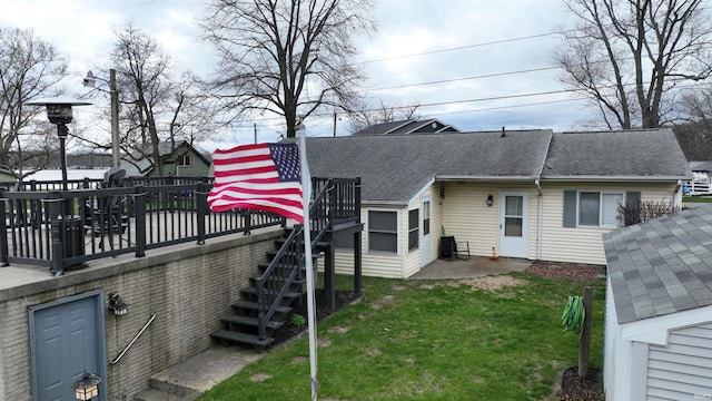 10509 N Lakeview Dr, Monticello, IN 47960 - rear view of property with roof with shingles, a yard, stairs, and a wooden deck