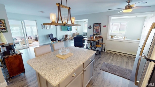 10509 N Lakeview Dr, Monticello, IN 47960 - kitchen featuring open floor plan, a wealth of natural light, a ceiling fan, and baseboard heating