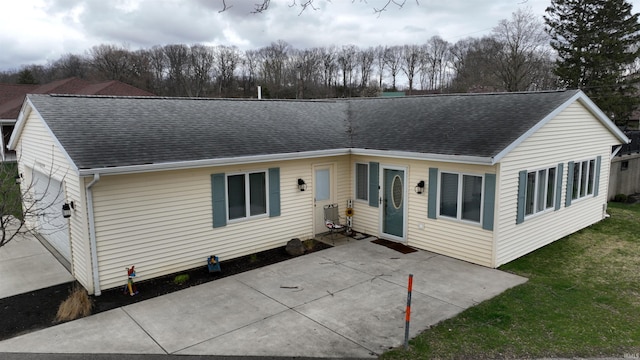 10509 N Lakeview Dr, Monticello, IN 47960 - single story home with a patio, a shingled roof, and a front lawn