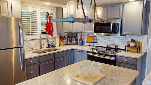 10509 N Lakeview Dr, Monticello, IN 47960 - kitchen featuring wall chimney range hood, stainless steel appliances, gray cabinets, and a sink