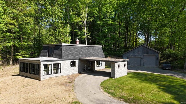 505 Longtree Ln, Logansport, IN 46947 - view of front of property with an outdoor structure, a front yard, a shingled roof, and a detached garage