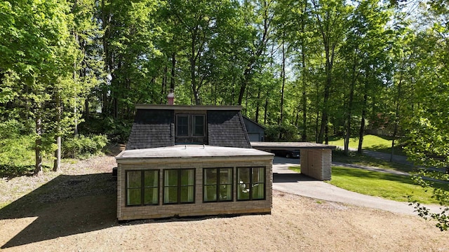 505 Longtree Ln, Logansport, IN 46947 - view of patio / terrace featuring an outdoor structure, dirt driveway, and a carport