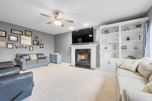 living area with a tile fireplace, carpet flooring, a ceiling fan, and recessed lighting