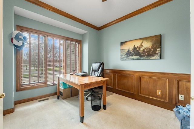 office area featuring ornamental molding, visible vents, wainscoting, and light carpet