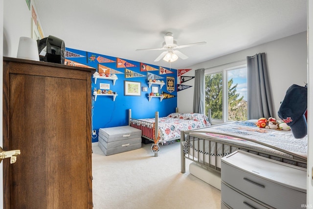bedroom featuring light carpet and a ceiling fan