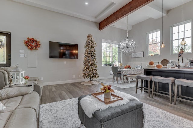 8780 N Old State Road 37th Rd, Bloomington, IN 47408 - living room with light wood-style flooring, an inviting chandelier, baseboards, and beam ceiling