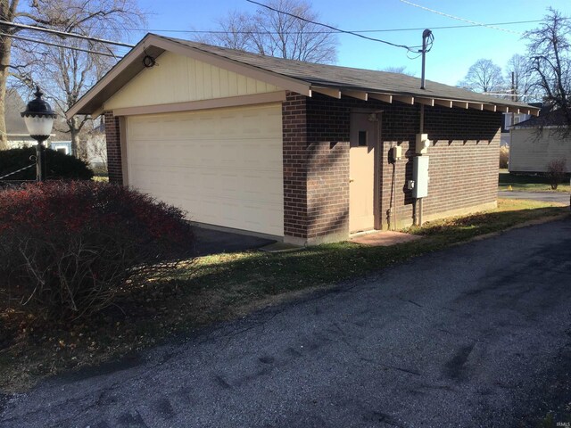 213 S Monticello St, Winamac, IN 46996 - view of property exterior featuring a garage and brick siding