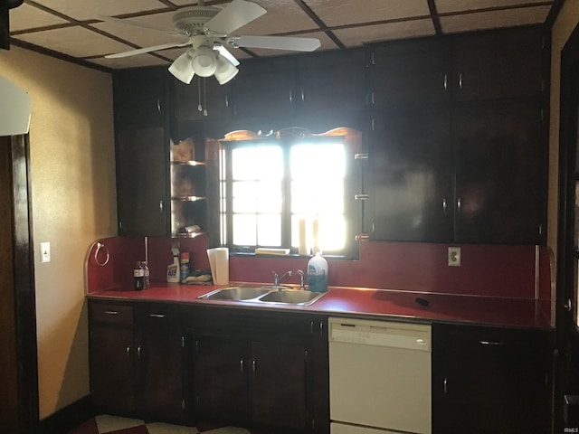 213 S Monticello St, Winamac, IN 46996 - kitchen featuring a paneled ceiling, a ceiling fan, dark cabinetry, white dishwasher, and a sink