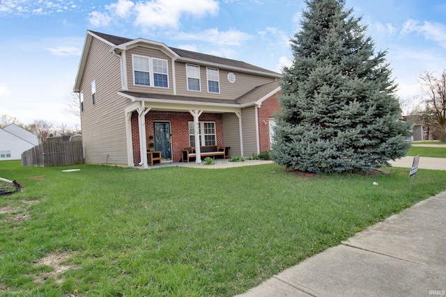 view of front of home with a front yard, fence, and brick siding