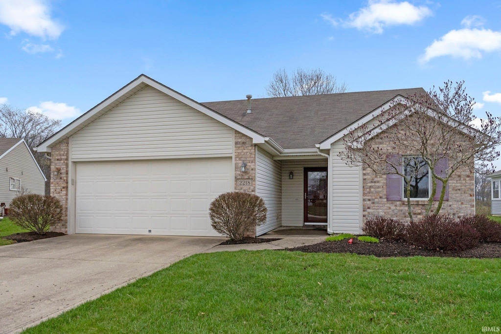 single story home with a front yard, roof with shingles, driveway, and an attached garage