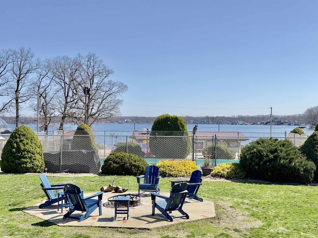 342 E Himes St, North Webster, IN 46555 - view of yard with an outdoor fire pit, a patio area, fence, and a water view