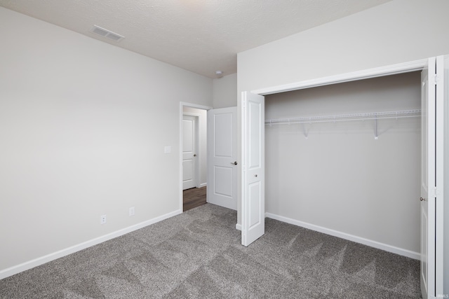 unfurnished bedroom with a closet, visible vents, baseboards, and carpet floors