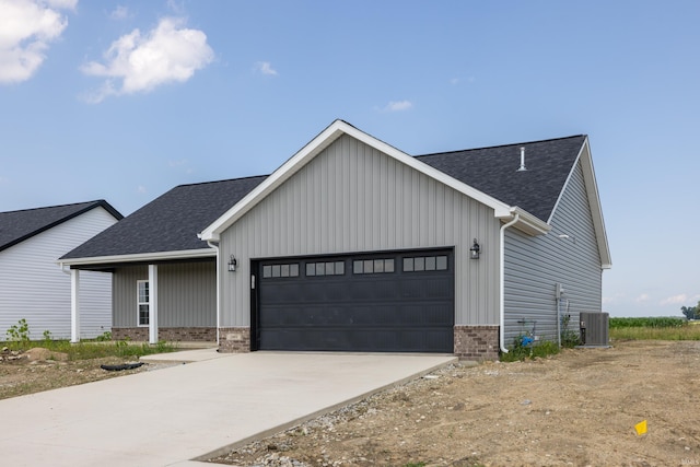 modern farmhouse style home featuring a garage, roof with shingles, brick siding, and concrete driveway