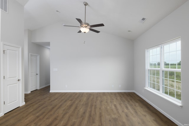 empty room with visible vents, baseboards, a ceiling fan, dark wood finished floors, and high vaulted ceiling