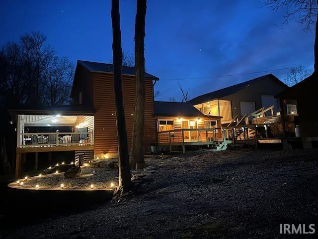 3008 Chigger Ridge Rd Unit 395, 396, Birdseye, IN 47513 - back of house at night with a deck