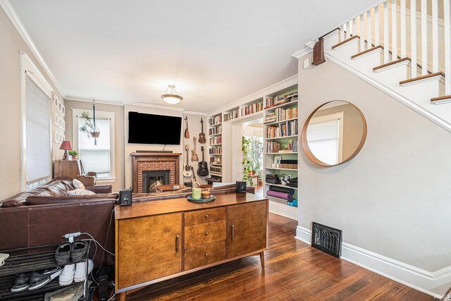 1069 Riverside Dr, South Bend, IN 46616 - living area with a fireplace, visible vents, dark wood-style flooring, baseboards, and built in shelves