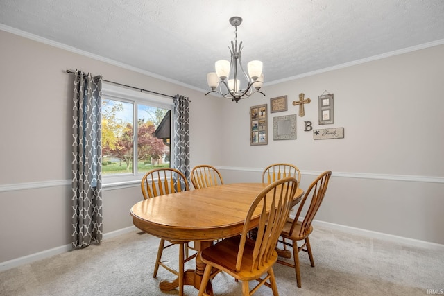 carpeted dining room featuring a chandelier, a textured ceiling, crown molding, and baseboards