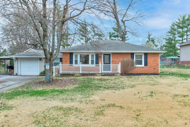 ranch-style house with aphalt driveway, a front yard, covered porch, and brick siding
