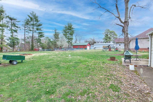 view of yard with fence and an outdoor fire pit