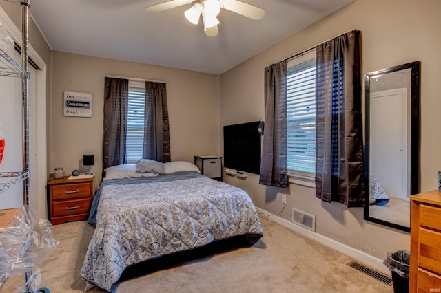 bedroom featuring visible vents, baseboards, carpet flooring, and ceiling fan