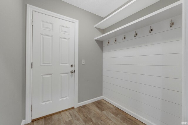 mudroom featuring light wood-type flooring and baseboards
