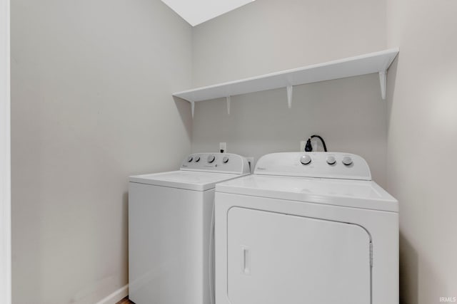 laundry room featuring separate washer and dryer and laundry area