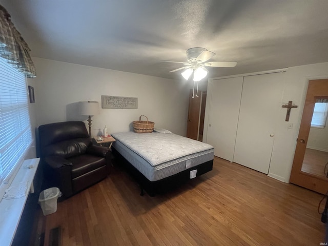 bedroom featuring a closet, ceiling fan, and wood finished floors