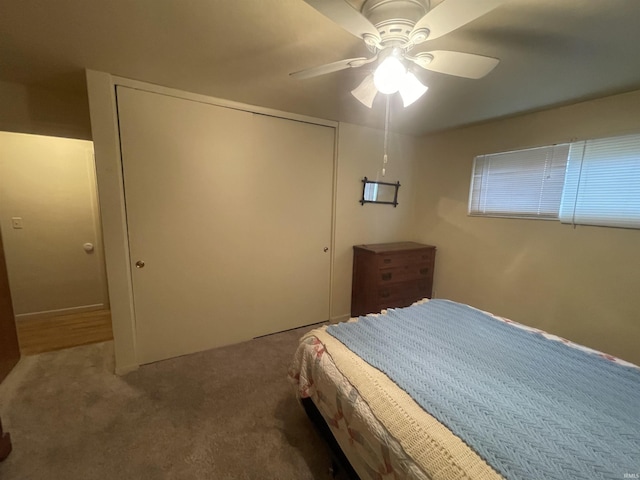 bedroom with a closet, a ceiling fan, and carpet flooring
