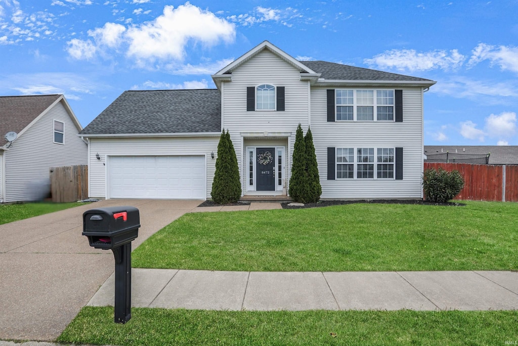 8472 Countrywood Ct, Newburgh, IN 47630 - view of front facade featuring a front lawn, fence, a garage, and driveway