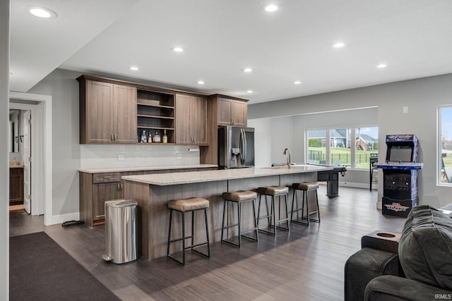 kitchen featuring recessed lighting, stainless steel fridge with ice dispenser, open shelves, and dark wood-style flooring