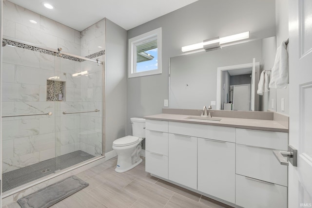 full bathroom featuring a shower stall, vanity, recessed lighting, toilet, and baseboards