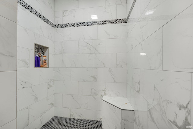 bathroom with tiled shower