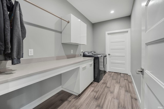 laundry room with independent washer and dryer, recessed lighting, wood finished floors, baseboards, and cabinet space