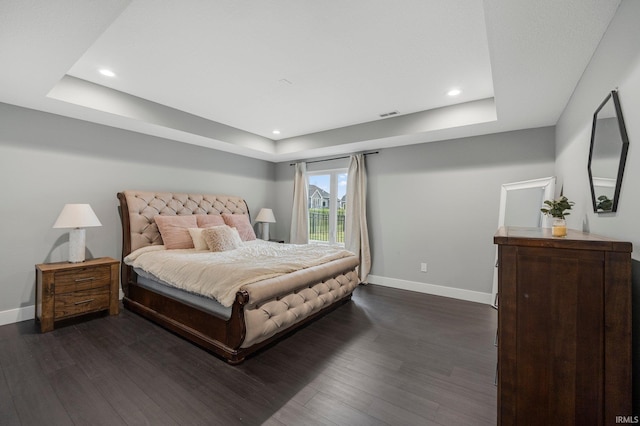bedroom with a raised ceiling, access to exterior, baseboards, and dark wood finished floors